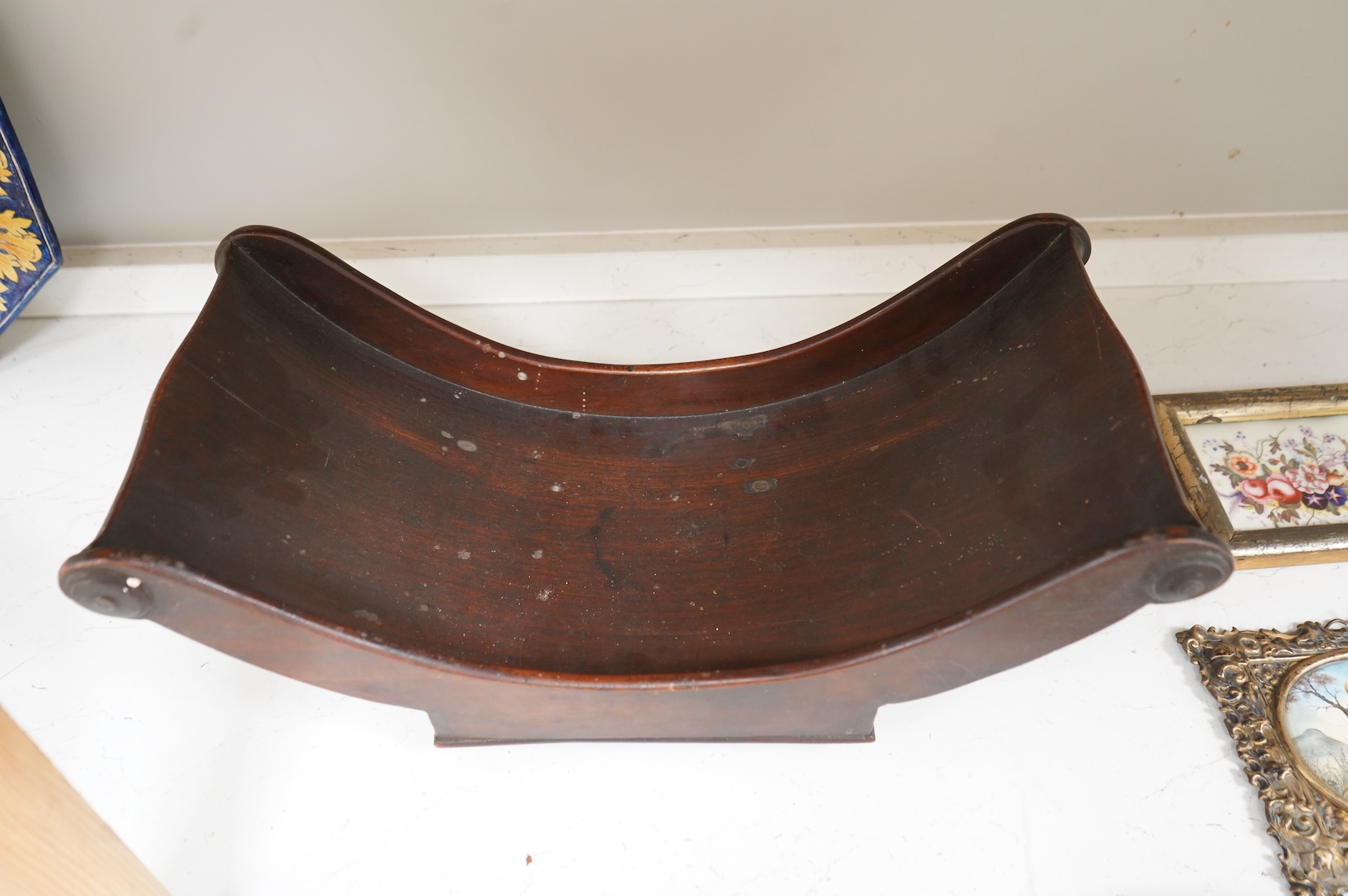 A George III mahogany cheese coaster, with original brass castors, 43cm wide
